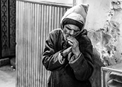 Mann rauchend in Gasse Schwarz-Weiß Streetfotografie